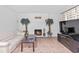 Bright living room featuring a fireplace, tile floors and decoratively placed palm trees at 321 Scotland Dr, Daytona Beach, FL 32117
