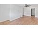 Bright living room with wood-look tile flooring, ceiling fan, and access to closet space at 321 Scotland Dr, Daytona Beach, FL 32117