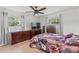 A furnished main bedroom with a ceiling fan, windows, and furniture creating a comfortable retreat at 321 Scotland Dr, Daytona Beach, FL 32117