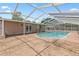Outdoor screened pool area with a large backyard and white pergola at 321 Scotland Dr, Daytona Beach, FL 32117