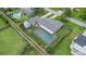 Aerial view of backyard with screened pool area, grass, and detached garage at 321 Scotland Dr, Daytona Beach, FL 32117