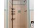 Shower featuring tiled walls, shower head, and built-in shelving unit at 321 Scotland Dr, Daytona Beach, FL 32117