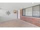 Brick accented sunroom featuring neutral tile floors, ample natural light and white trim at 321 Scotland Dr, Daytona Beach, FL 32117