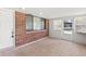 Sunroom with tile flooring, a white door and trim, and large windows for natural light at 321 Scotland Dr, Daytona Beach, FL 32117