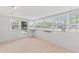 Bright sunroom with neutral tile floors and large windows providing ample natural light at 321 Scotland Dr, Daytona Beach, FL 32117