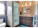 Bathroom featuring a shower and vanity with decorative mirror at 35 Whippoorwill Ln, Ormond Beach, FL 32174