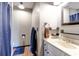 A well-lit bathroom featuring a vanity and a shower with a blue shower curtain at 35 Whippoorwill Ln, Ormond Beach, FL 32174