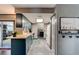 Galley kitchen featuring blue cabinets, wood countertops and modern lighting at 35 Whippoorwill Ln, Ormond Beach, FL 32174