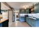 Kitchen featuring blue cabinets, modern appliances, and an open layout at 35 Whippoorwill Ln, Ormond Beach, FL 32174