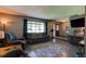 Comfortable living room featuring polished concrete floors and a large window for natural light at 35 Whippoorwill Ln, Ormond Beach, FL 32174