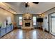 Living room featuring a stone fireplace, hardwood floors, and modern lighting at 35 Whippoorwill Ln, Ormond Beach, FL 32174