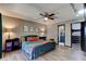 Inviting main bedroom featuring stylish wood floors, a ceiling fan, and an ensuite bathroom, creating a serene retreat at 35 Whippoorwill Ln, Ormond Beach, FL 32174