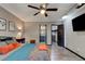 Cozy main bedroom with a ceiling fan, tv, and ensuite bathroom at 35 Whippoorwill Ln, Ormond Beach, FL 32174