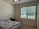 Bedroom featuring neutral paint, carpet floors, and a large window at 551 Shaelyn Pl, Deland, FL 32724