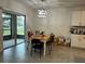 Bright dining room with sliding glass doors, tile floors, and a stylish chandelier at 551 Shaelyn Pl, Deland, FL 32724