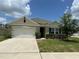 Charming single Gathering home with a well-manicured lawn and a two car garage at 551 Shaelyn Pl, Deland, FL 32724
