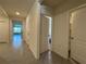 Hallway featuring neutral paint, ceramic tile floor and several access doors at 551 Shaelyn Pl, Deland, FL 32724
