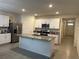 Bright, modern kitchen with white cabinetry, stainless steel appliances and granite countertops at 551 Shaelyn Pl, Deland, FL 32724