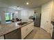 Open-concept kitchen features a granite island and stainless steel appliances at 551 Shaelyn Pl, Deland, FL 32724