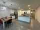 Open layout showcasing modern kitchen with island, stainless steel appliances, and dining area at 551 Shaelyn Pl, Deland, FL 32724