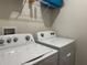 Bright laundry room featuring a Whirlpool washer and dryer with convenient overhead shelving at 551 Shaelyn Pl, Deland, FL 32724