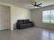 Open living room featuring tile floors, a ceiling fan, and lots of natural light at 551 Shaelyn Pl, Deland, FL 32724