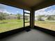 Enclosed patio with screen and view of the backyard and neighboring homes at 551 Shaelyn Pl, Deland, FL 32724