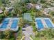 Aerial view of the community tennis and basketball courts offers a great way to stay active at 1 Crooked Bridge Way, Ormond Beach, FL 32174
