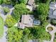 Aerial shot of a home with a screened pool, mature trees, and a well-manicured lawn in a neighborhood at 1 Crooked Bridge Way, Ormond Beach, FL 32174