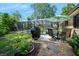 Inviting backyard with outdoor grill, patio, lush greenery, and screened pool, creating a perfect space for relaxation at 1 Crooked Bridge Way, Ormond Beach, FL 32174