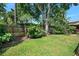 Spacious backyard with mature trees, a well-maintained lawn, and privacy fence, ideal for outdoor activities at 1 Crooked Bridge Way, Ormond Beach, FL 32174