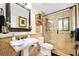 Elegant bathroom featuring a glass-enclosed shower, pedestal sink, and tasteful decor at 1 Crooked Bridge Way, Ormond Beach, FL 32174
