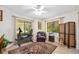 Versatile bedroom featuring windows, hardwood floors and seating area at 1 Crooked Bridge Way, Ormond Beach, FL 32174