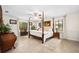 Serene bedroom features a four-poster bed, neutral tones and many windows at 1 Crooked Bridge Way, Ormond Beach, FL 32174