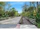 Community bridge with wooden plank path is surrounded by lush landscaping on a sunny day at 1 Crooked Bridge Way, Ormond Beach, FL 32174