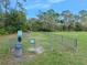 Community dog park features a fenced-in area for dogs to play and exercise, along with waste stations at 1 Crooked Bridge Way, Ormond Beach, FL 32174