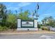 Breakaway Trails entrance sign surrounded by greenery on a sunny day at 1 Crooked Bridge Way, Ormond Beach, FL 32174