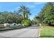 Community entrance sign for Breakaway Trails with lush landscaping and a palm tree at 1 Crooked Bridge Way, Ormond Beach, FL 32174