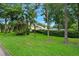 Beautifully landscaped property surrounded by mature trees and lush greenery at 1 Crooked Bridge Way, Ormond Beach, FL 32174