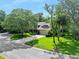 Beautiful two-story home with lush landscaping and a spacious driveway, surrounded by mature trees at 1 Crooked Bridge Way, Ormond Beach, FL 32174