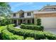 Charming two-story home with a brick facade, manicured landscaping, and a welcoming front porch at 1 Crooked Bridge Way, Ormond Beach, FL 32174