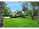 Beautifully landscaped front yard with lush green grass and mature trees surrounding the home at 1 Crooked Bridge Way, Ormond Beach, FL 32174