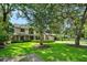 Charming two-story home with a manicured lawn and mature trees providing shade at 1 Crooked Bridge Way, Ormond Beach, FL 32174