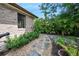 Lush backyard garden with stone pathway, vibrant flowers, and well-manicured shrubs for a tranquil outdoor experience at 1 Crooked Bridge Way, Ormond Beach, FL 32174