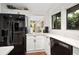 Modern kitchen features stainless steel appliances, white marble counter tops and tile backsplash, perfect for cooking enjoyment at 1 Crooked Bridge Way, Ormond Beach, FL 32174