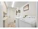Bright laundry room with washer, dryer, utility sink, cabinets, and convenient exterior door at 1 Crooked Bridge Way, Ormond Beach, FL 32174