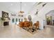 Bright and spacious living room with a fireplace, high ceilings, and views of the outdoor pool area at 1 Crooked Bridge Way, Ormond Beach, FL 32174