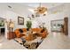 Open-concept living room with high ceilings, a modern ceiling fan, and a cozy seating area at 1 Crooked Bridge Way, Ormond Beach, FL 32174