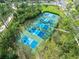Aerial view showcases multiple pickleball courts, providing ample opportunities for community recreation at 1 Crooked Bridge Way, Ormond Beach, FL 32174