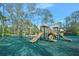 Community playground with multiple slides, climbing structures, and a soft green surface at 1 Crooked Bridge Way, Ormond Beach, FL 32174